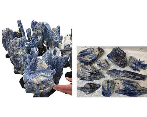 Kyanite rough stone for sale wholesale to shops stores museums blue with white striations seen sitting in large pile and smaller pieces on a table surface